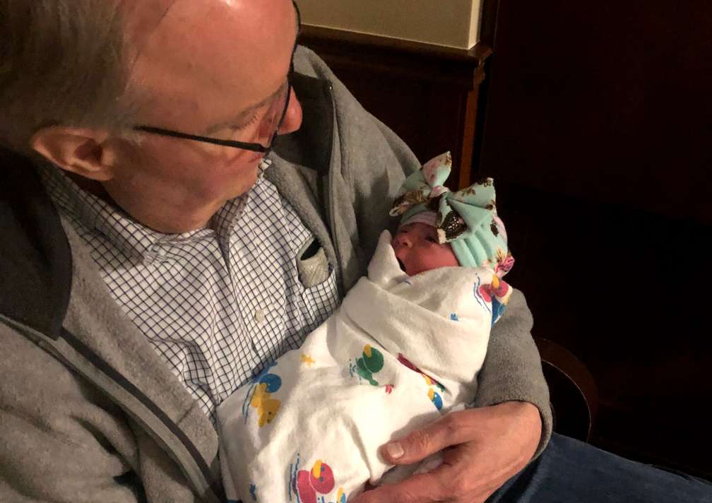 Bryce Wray holds his new granddaughter, Kennedy Beck, on the night of her birth