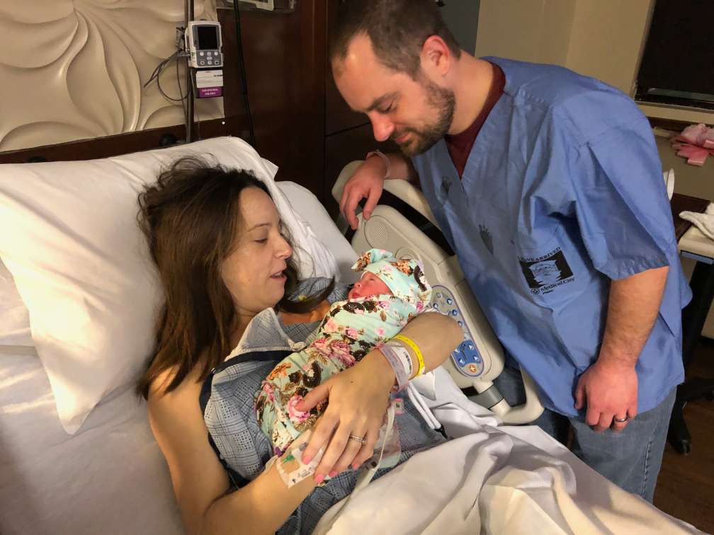 Brad and Sarah Beck (the latter is our daughter) admire their new child, Kennedy, less than an hour after her arrival